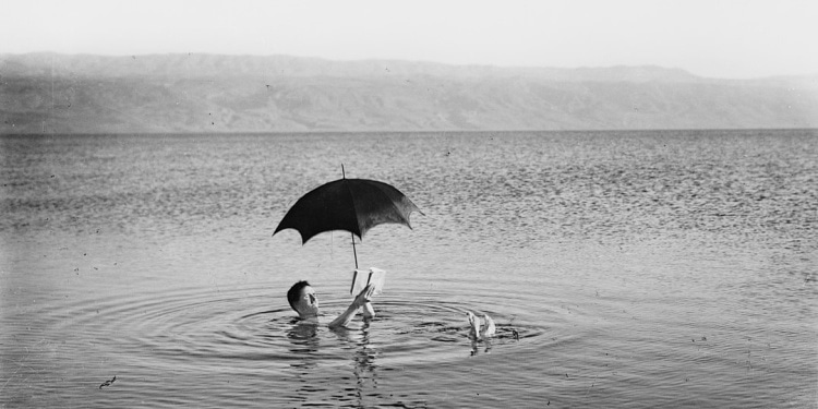 Man floating on the waters of the Dead Sea in Israel, 1925