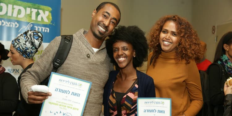 Smiling family of three holding IFCJ branded graduation papers.