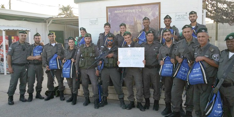 Large group of soldiers with IFCJ backpacks.
