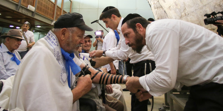 Rabbis holding a bar mitzvah for Holocaust survivors.
