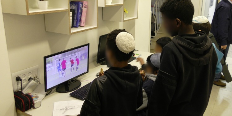 Five young boys on computers at Neve Michael Children's Home.