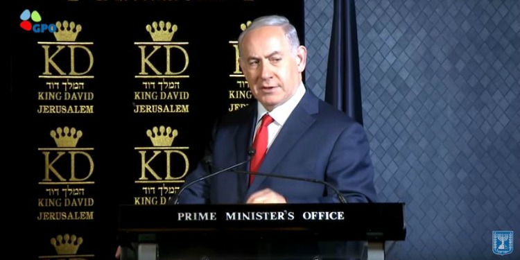 Bibi giving a speech at the podium of the Prime Minister's Office.