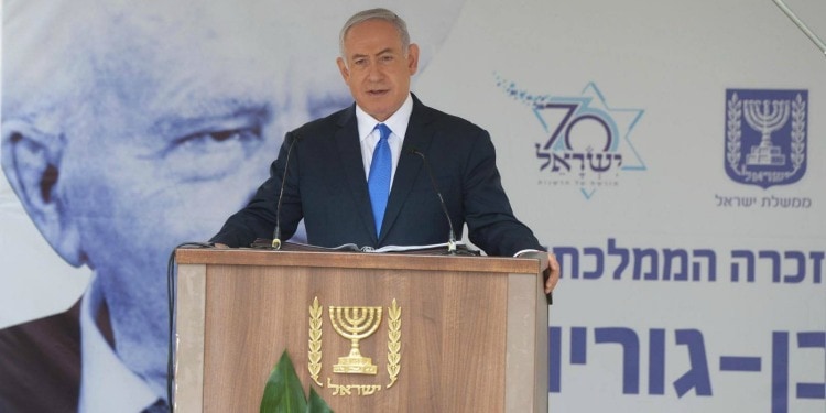 Bibi standing at a podium giving a speech.