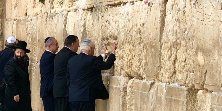 Five men praying at the Western Wall.