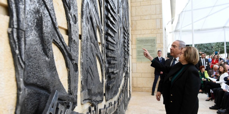 Bibi and a woman looking at a memorial.