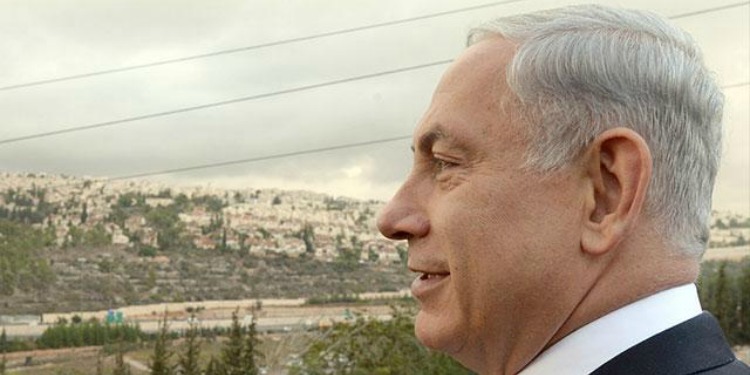 Bibi overlooking mountains and a highway in Jerusalem.