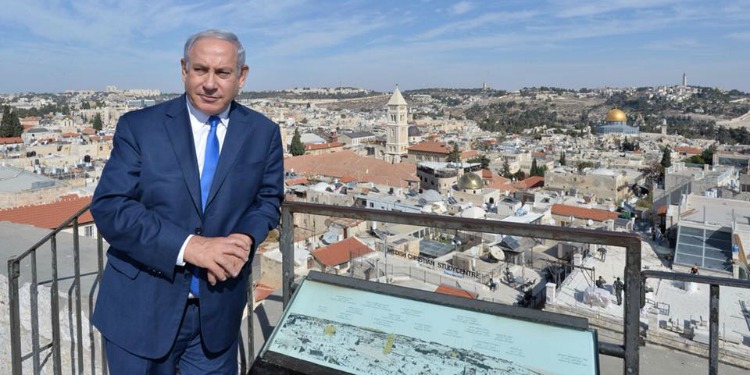 Bibi standing on a balcony in the middle of Jerusalem.