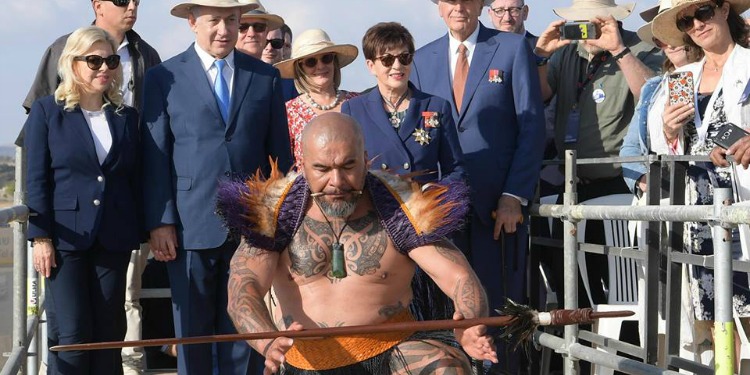 A man in a feather costume performing in front of a crowd including Bibi.