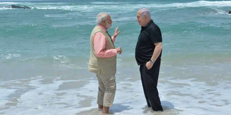 Bibi and Modi talking as they stand calf deep in a sea.