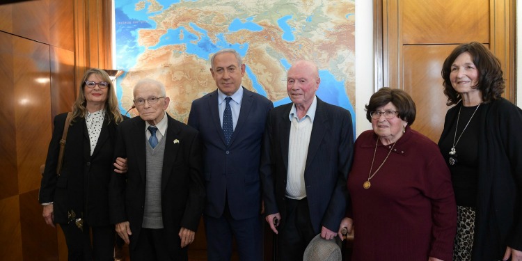 Bibi standing with several Holocaust survivors.