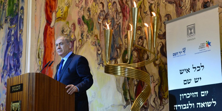 Bibi standing at a podium at the Holocaust Memorial.