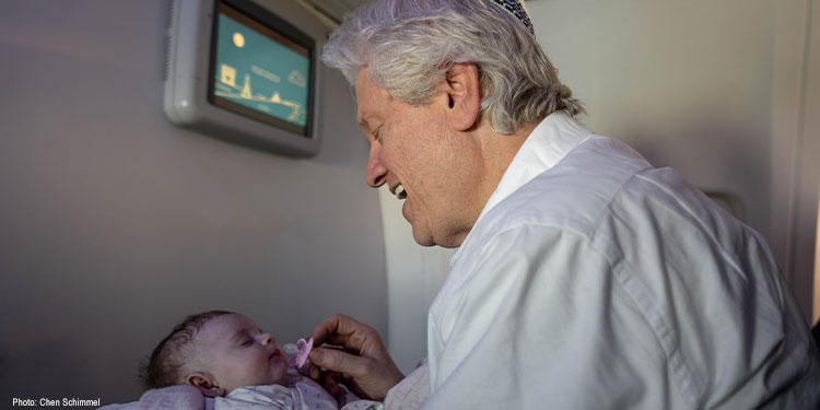 Bishop Lanier holding a newborn baby