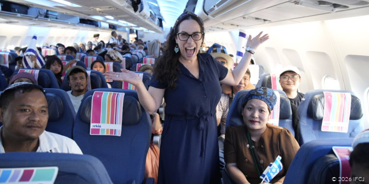 Joyful woman celebrating on the second Bnei Menashe freedom flight with passengers onboard, symbolizing hope and new beginnings for the community.