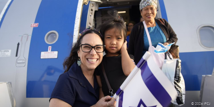 Compassionate humanitarian aid provided by IFCJ, featuring volunteers assisting families and children in need at an airplane departure.