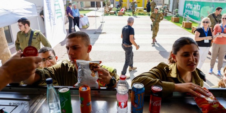 IDF soldiers getting snacks from an IFCJ sponsored hospitality vehicle.