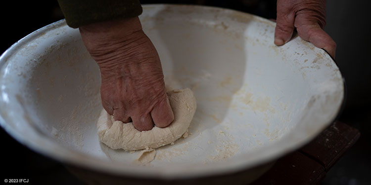 Image of someone mixing dough in a bowl