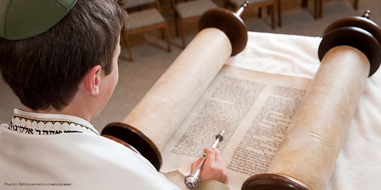 Young Jewish boy reading the Torah on Simchat Torah holiday.