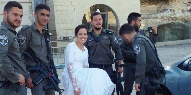 Bride poses at Western Wall with IDF soldiers