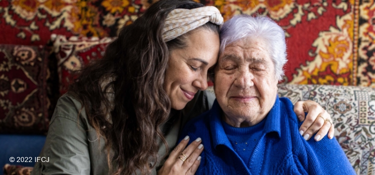 Yael with arm around elderly woman