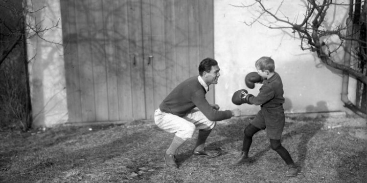 Man and boy play boxing