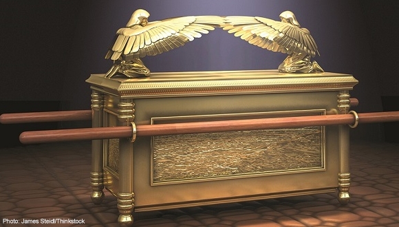 A golden ark of the covenant with two eagles on it.