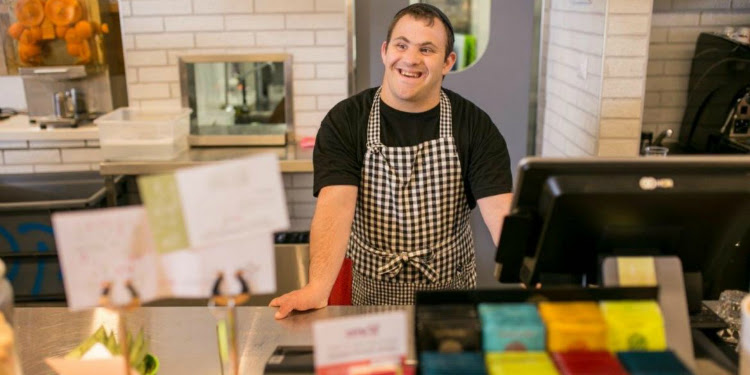 A person working the counter at an Israeli cafe.