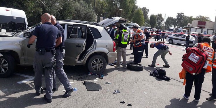 Two detectives and four paramedics by a car that was in a ramming.