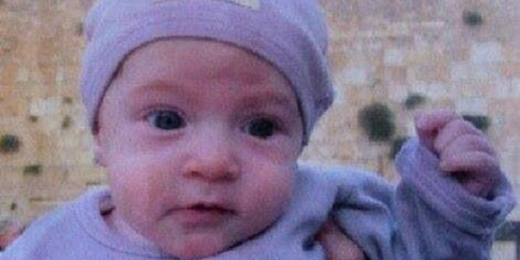 A young baby in a matching onesie and hat.