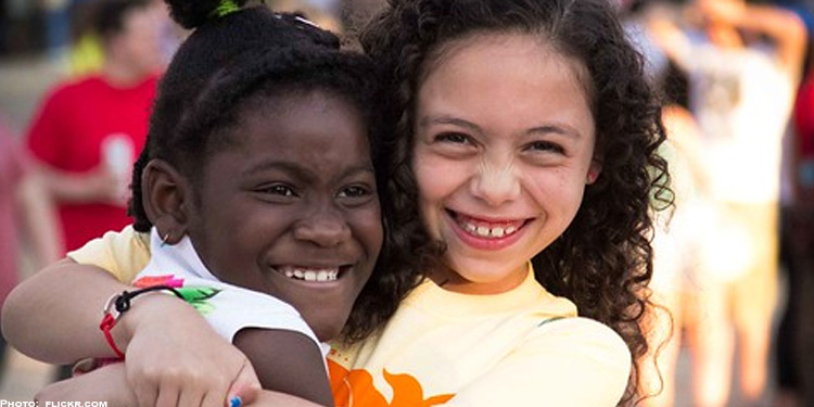 Two little girls hugging each other