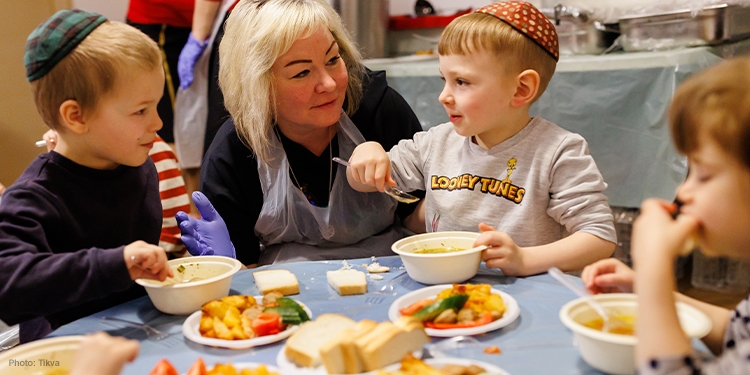 Children sitting at a table eating