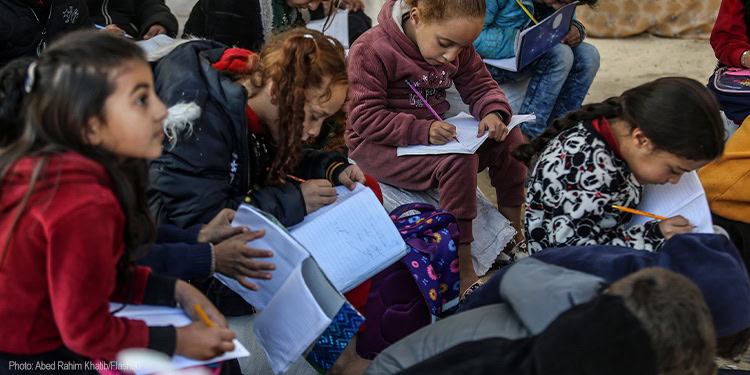 Children studying in a tent