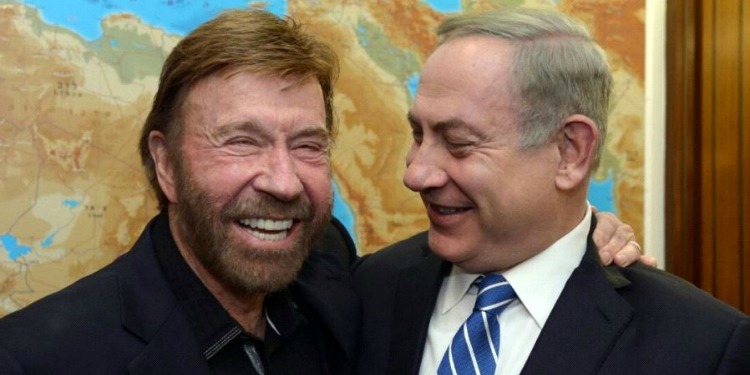 Chuck Norris and Bibi smiling at each other.