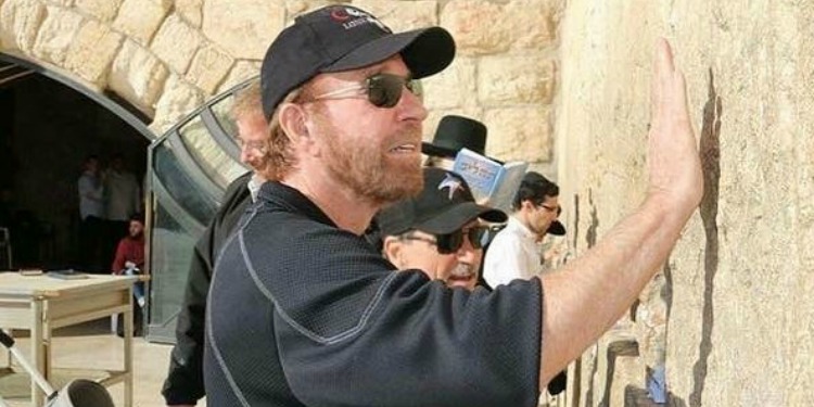 Chuck Norris putting his hand up against the Western Wall.