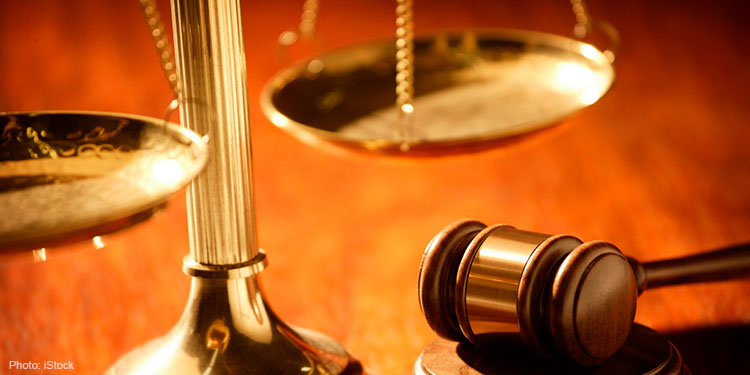 Close up image of gavel and balance scale.