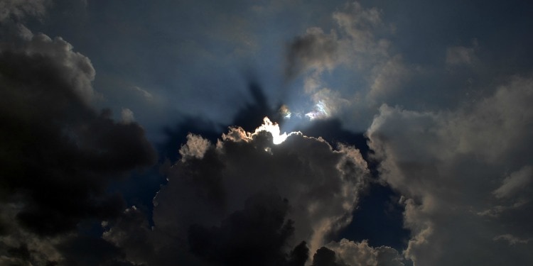 Several clouds in a dark sky.