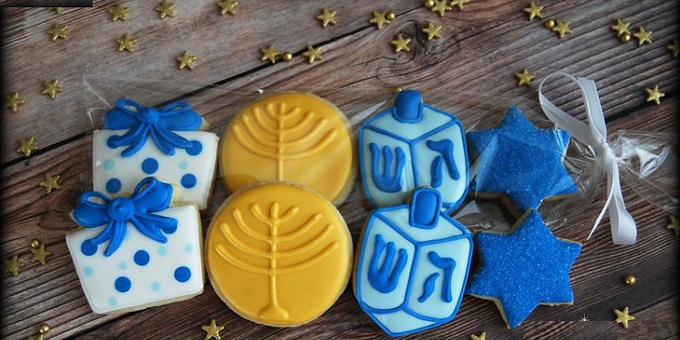 A gift bag of cookies shaped and decorated for Hanukkah