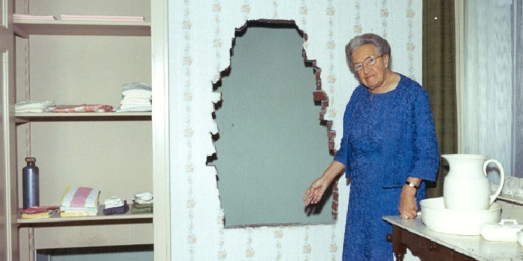 Corrie Ten Boom shows the hiding place where she hid Jews during the Holocaust