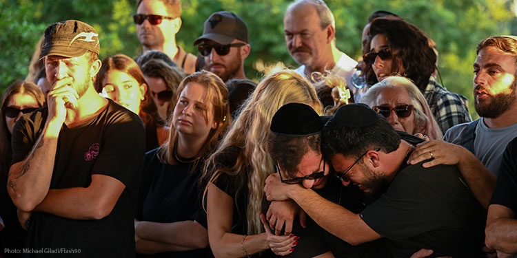 Crowd of people mourning at a funeral