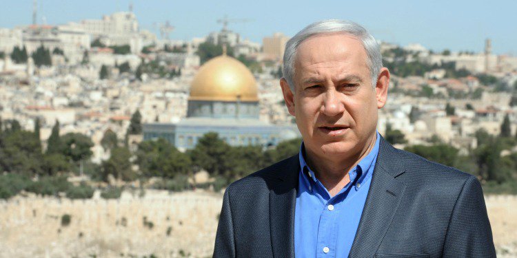 Headshot of Bibi with Jerusalem behind him.