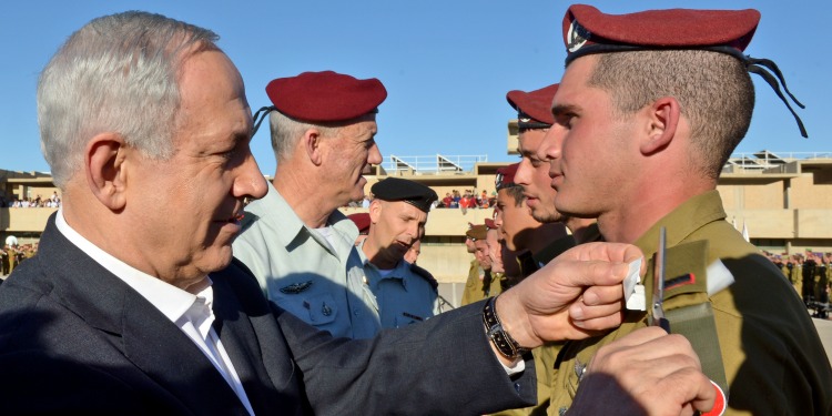 Bibi awarding a young IDF solider.
