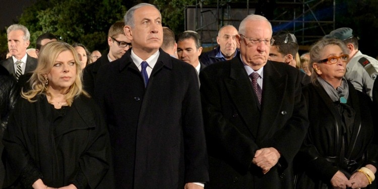 Bibi and others standing in all black outfits.