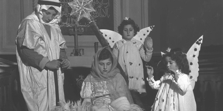 Four children acting out the Nativity scene.