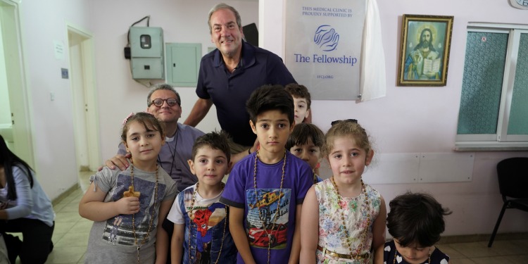 Rabbi Eckstein standing with children at a medical center supported by The Fellowship.