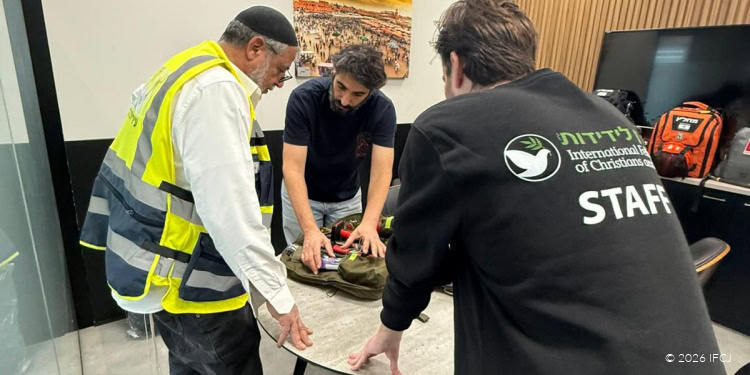International Christian Relief team providing aid and support to people affected by a crisis, demonstrating compassion and teamwork in a challenging environment.