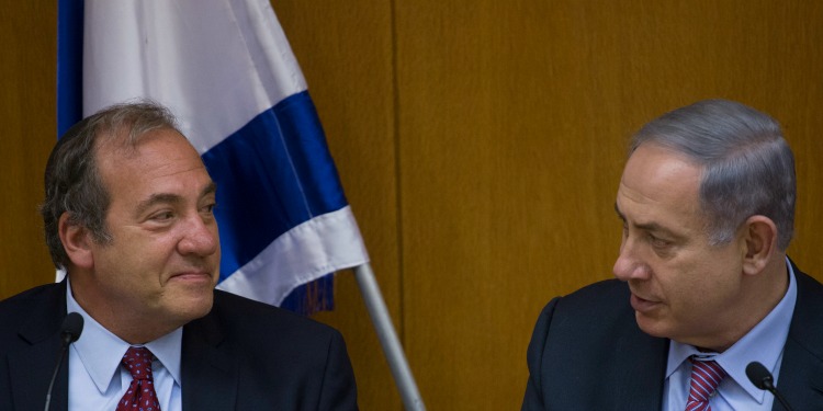 Rabbi Eckstein and Bibi sitting together discussing at a conference set up with mics.