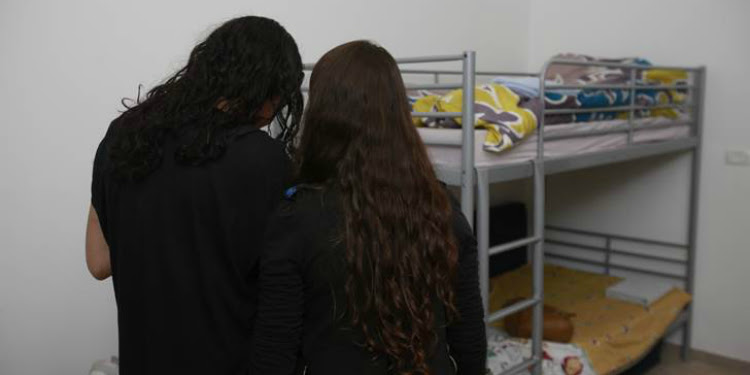 Two young girls in their room at a shelter for youth at risk.