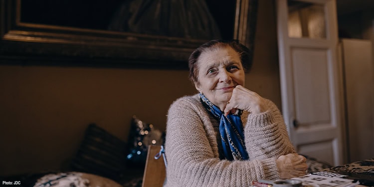 Elderly lady sitting at a table