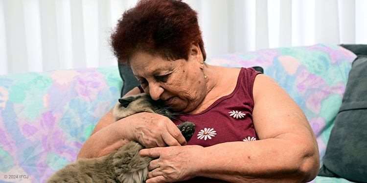 Elderly woman holding her cat
