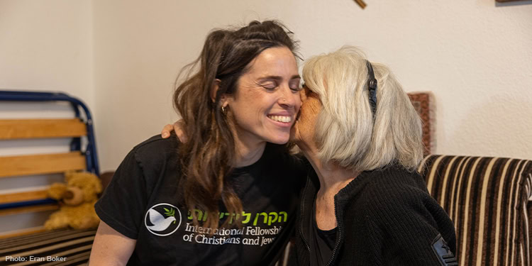 Elderly woman kissing ICJ Saff on the cheek