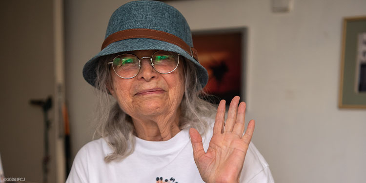 Elderly woman waving goodbye